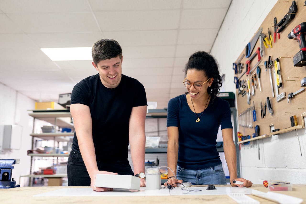 services-01 Two engineers collaborate in a workshop, engaging in hands-on prototyping and design.